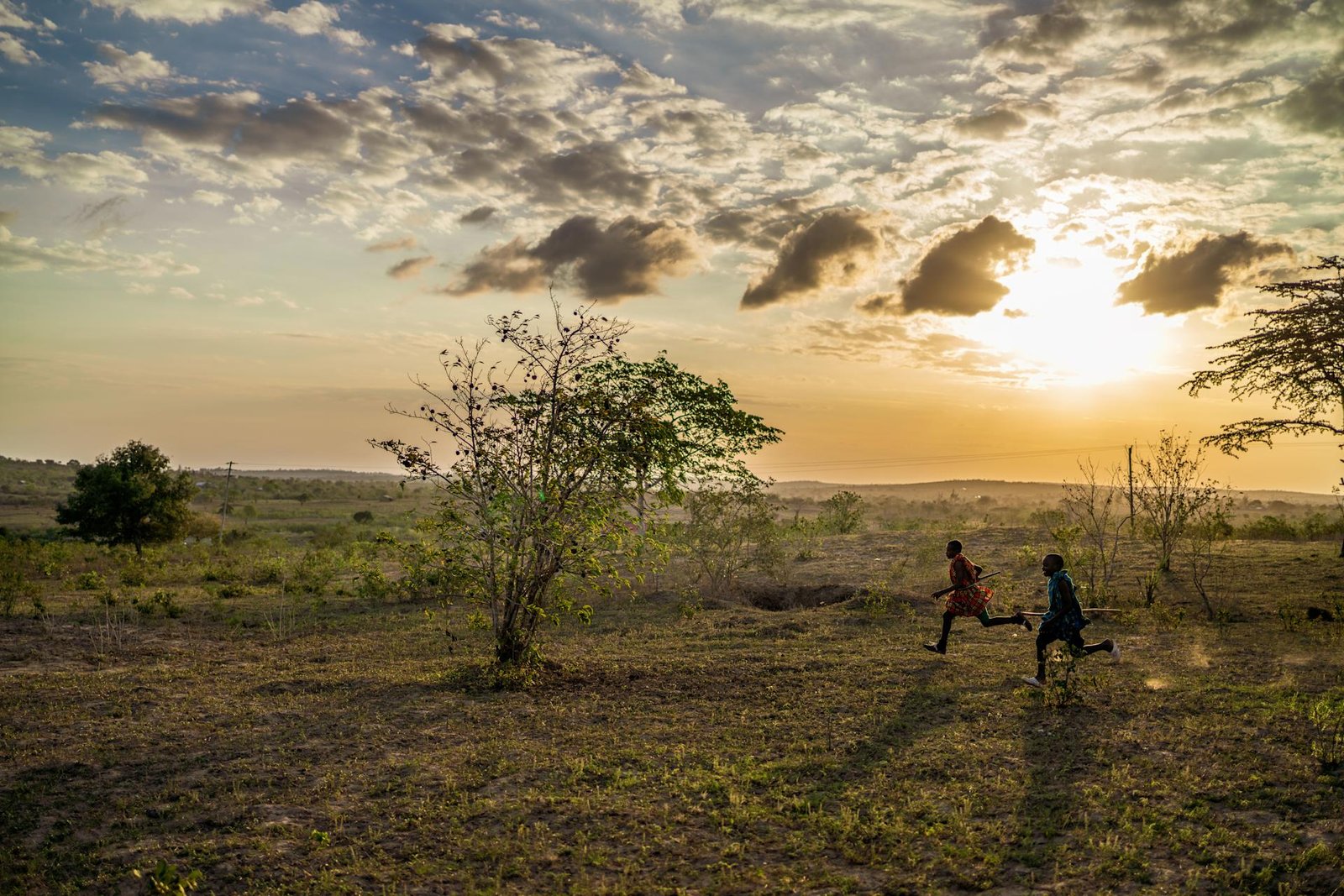 Children in everyday clothes walking together in warm afternoon light